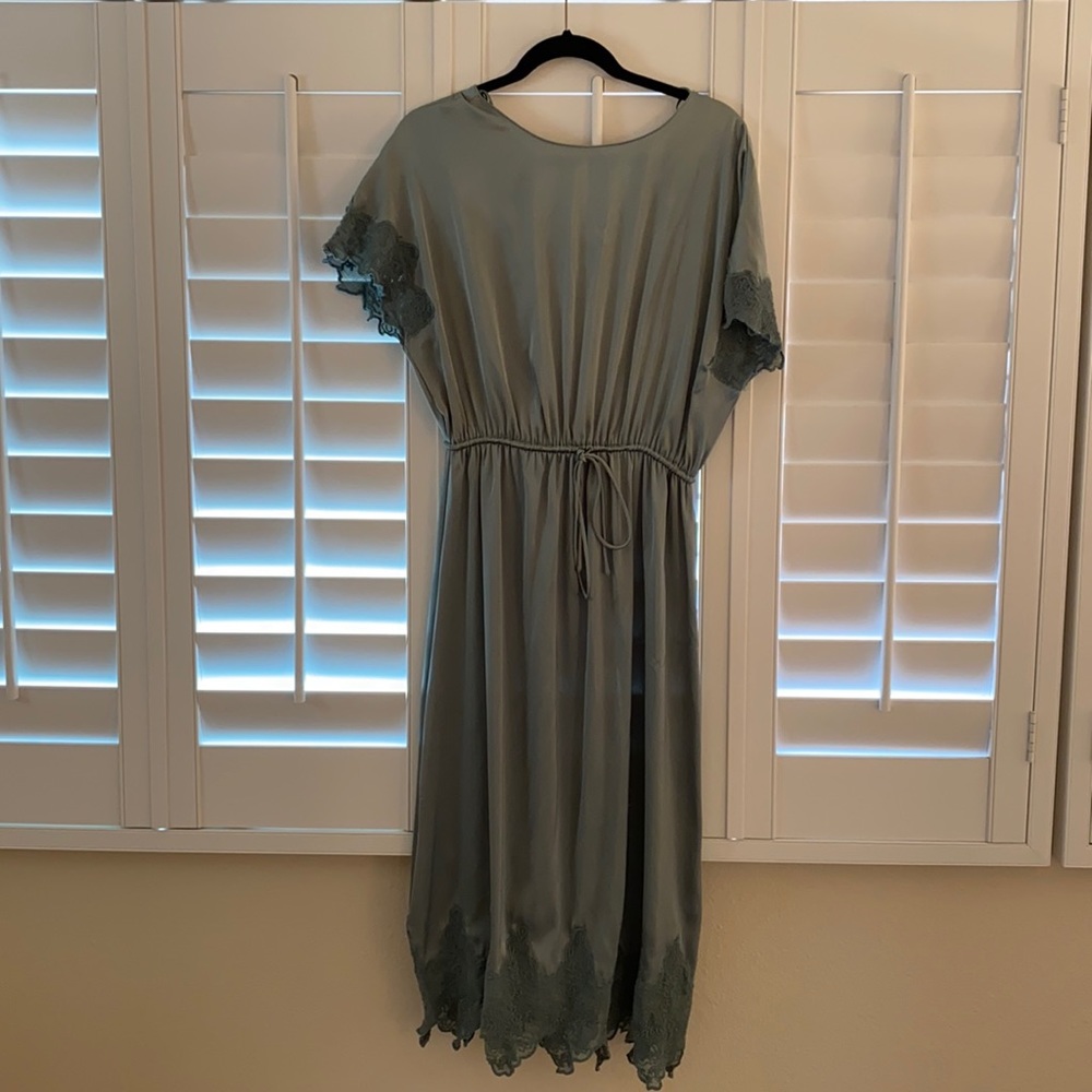 Satin dress with lace trim.